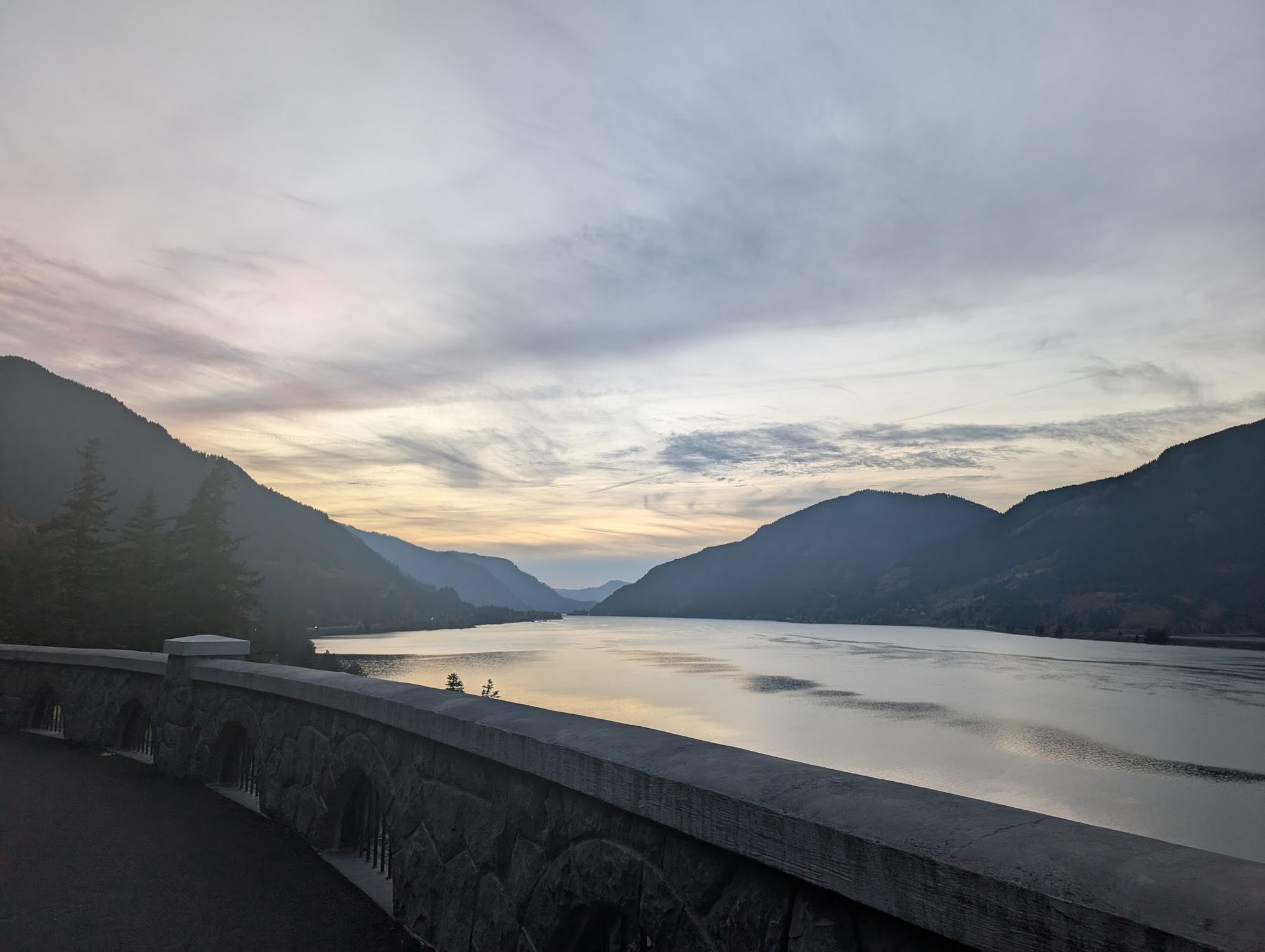 The Columbia River winding between mountains at dusk